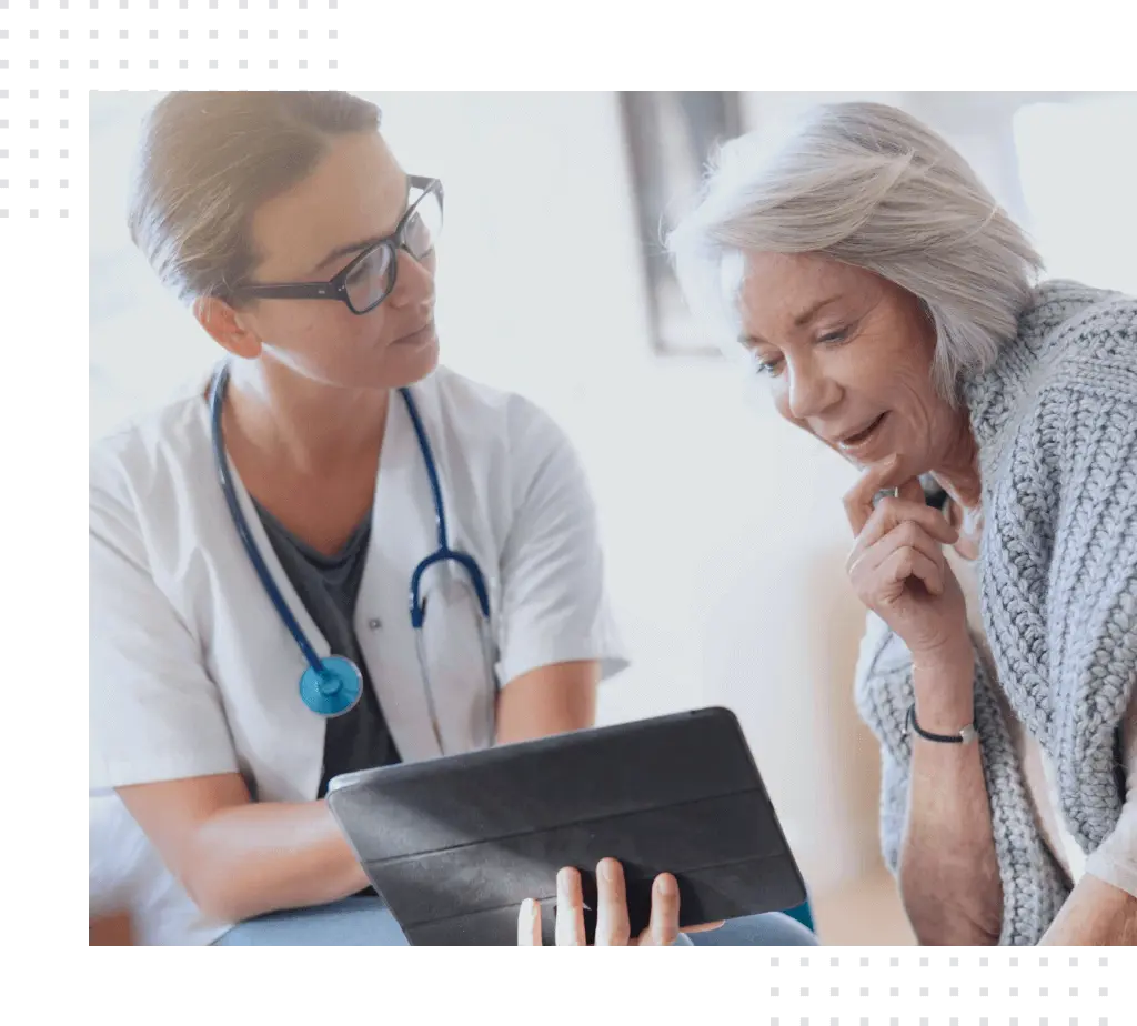 Doctor and patient look at the tablet and discuss, big image